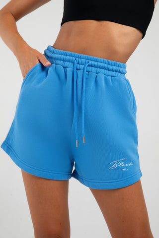 Model wearing Terry High Waisted Short Bloch Azure Blue front view close up
