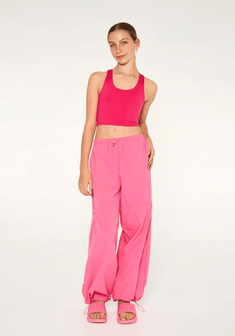 Dance model is wearing Claudia Dean Parachute Pants Bubblegum front view